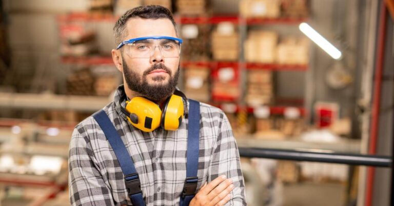 non smiling warehouse worker with arms crossed
