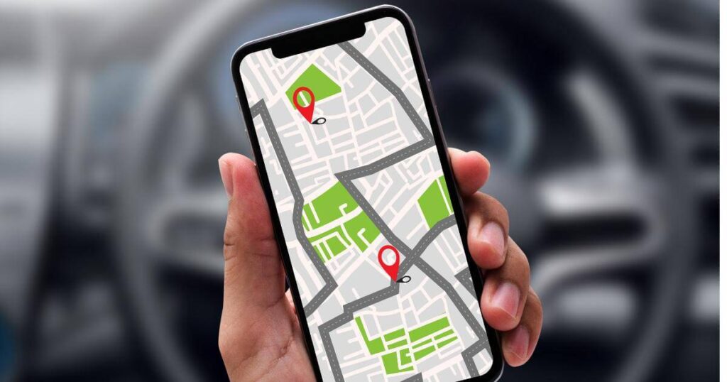 Person holding a phone with map directions, planning a route to a job site