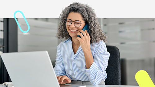 Selectemp recruiter on the phone at a desk, working a job order