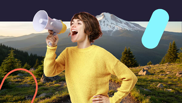 Woman shouting into a megaphone with Oregon mountains in the background