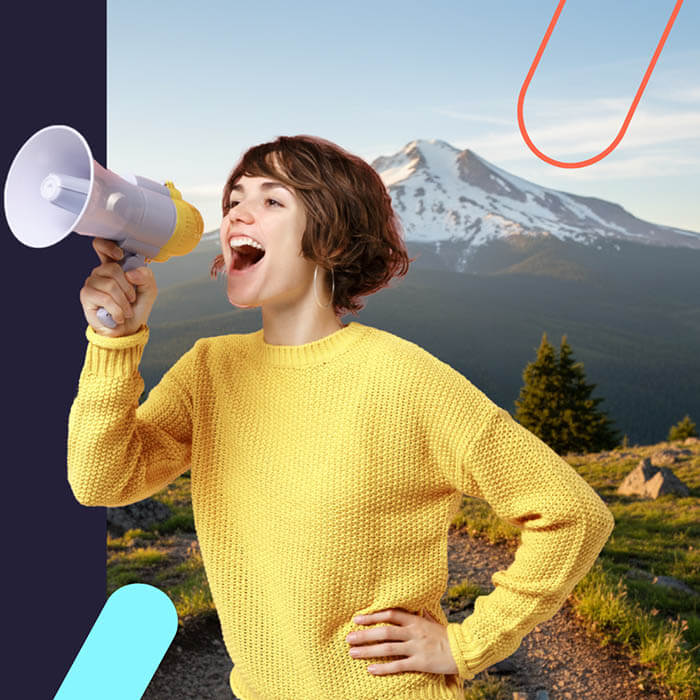 Woman shouting into a megaphone with Oregon mountains in the background
