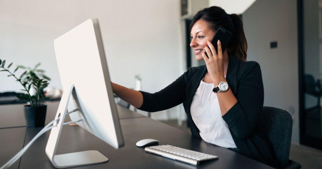 woman on phoen in office representing hybrid office coverage staffing