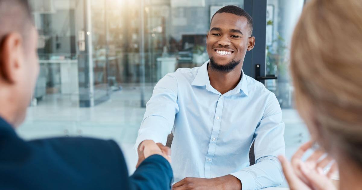 young interviewee shaking hands with interviewer for seasonal job