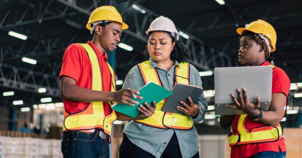 three manufacturing workers looking concerned