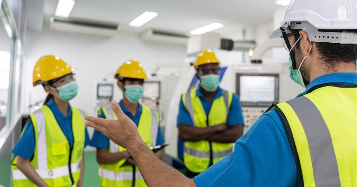 employees wearing hard hats and safety vests